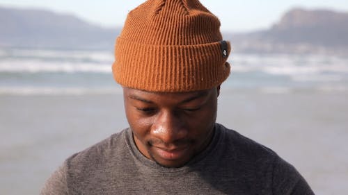 Close-up Video of Masculine Man in Knitted Bonnet at the Beach