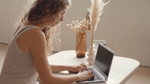 Woman Typing in a Laptop
