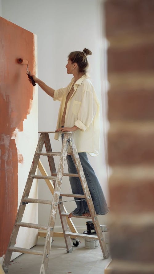 Woman Paiting a Wall