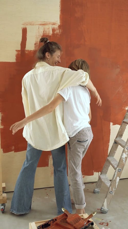 Adult and Child Painting a Wall