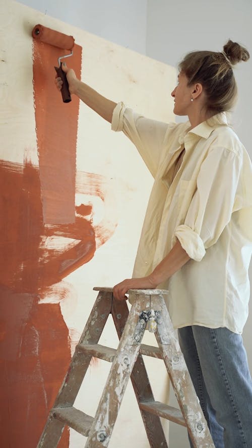 Person Painting a Wall