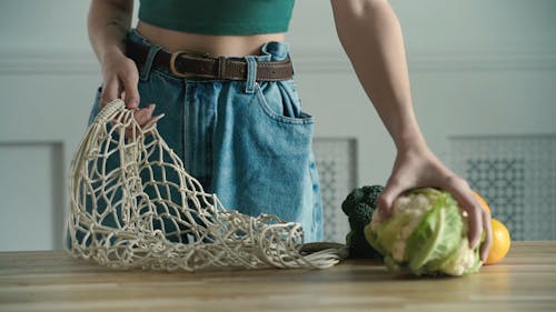 Person Holding a Vegetable and Fruits