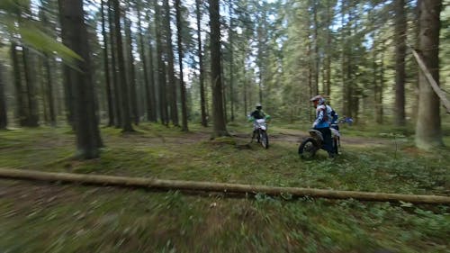Aerial Footage of Two Motorcylists in the Forest 