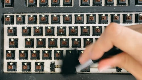 Person Brushing a Mechanical Keyboard Switch