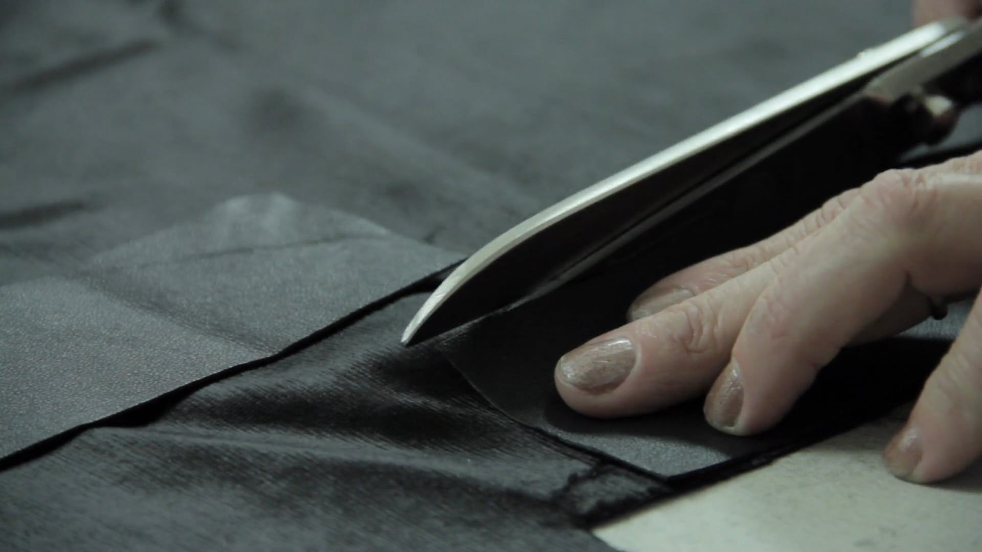 Person Cutting Black Fabric With Scissors · Free Stock Video