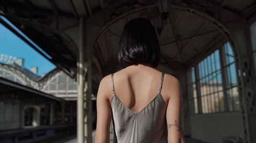 Woman Walking and Modeling in a Train Station 