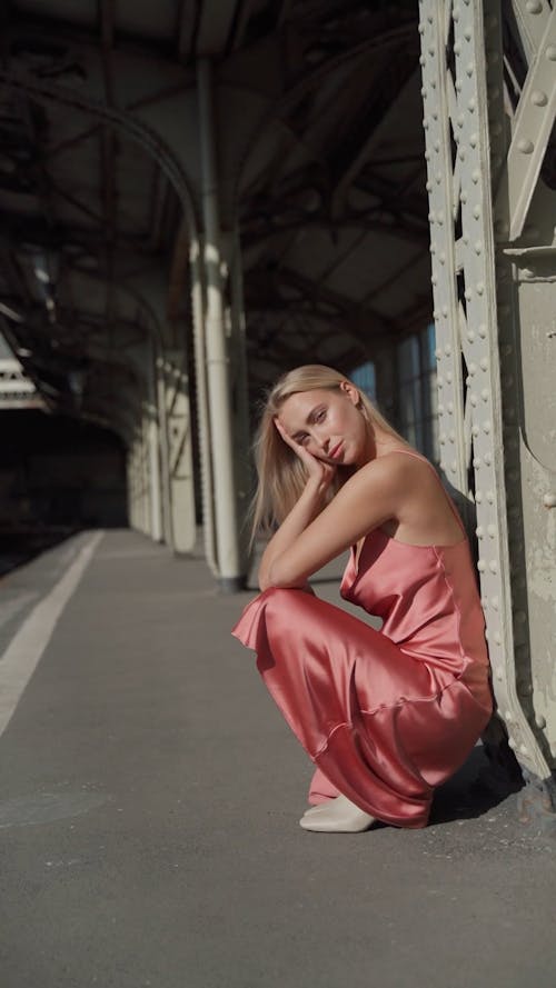 Woman in a Pink Dress Modeling in a Train Station 