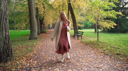 A Woman Running on a Pathway