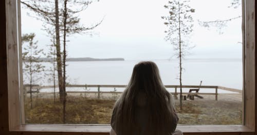Woman at Window Looking at the Lake