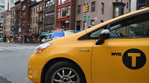 Close Up Shot of a Yellow Taxi Turning Left