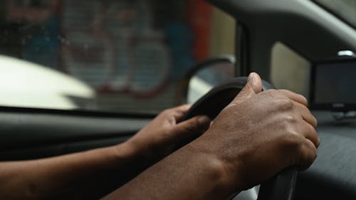 Video of a Person Driving and Holding the Steering Wheel 