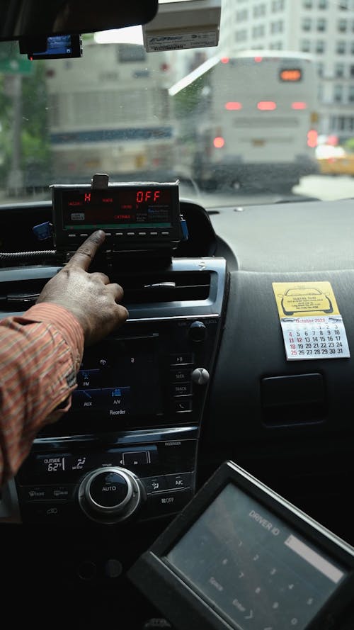 Vertical Video of a Man Setting the Taxi Meter