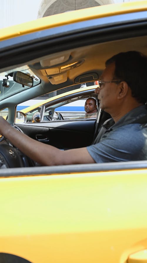 Two Men Talking While Inside Their Cars