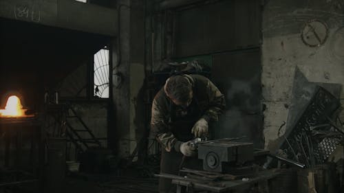 Young Man Working at Smithy Workshop