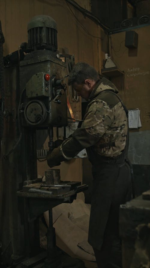 Young Man Using Workshop Machine