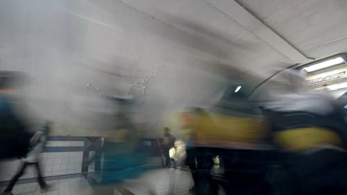 A Crowd of Commuters Walking in a Tunnel