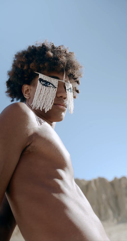 Vertical Video of a Man with Flexible Arms in the Desert