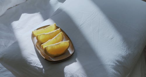 person Taking Lemon Slices from a Plate