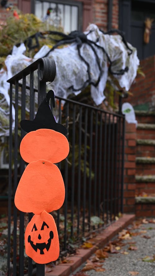 Paper Cutout of a Jack-o'-lantern Hanging on a Fence