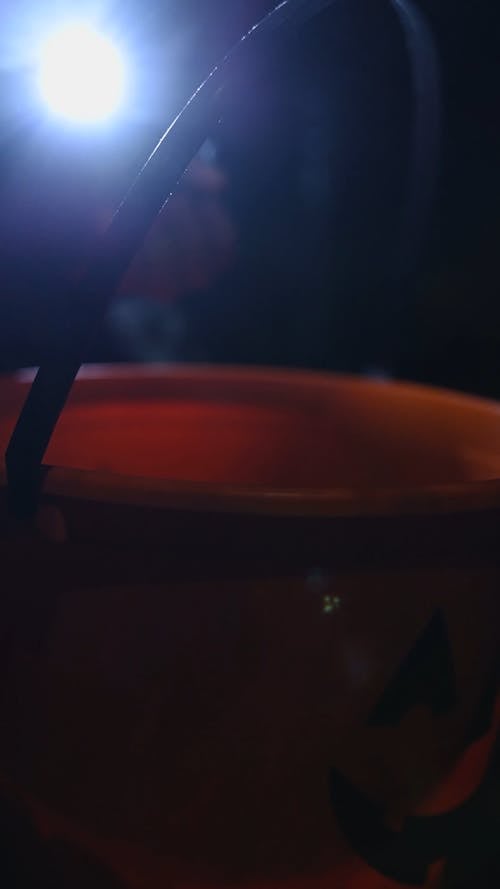 Children Putting Candies in a Bucket