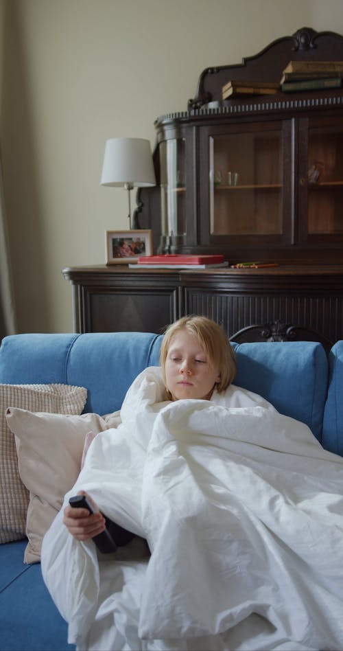 Boy Sitting on Sofa Watching Television