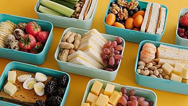 bowls of colorful healthy food on a yellow table