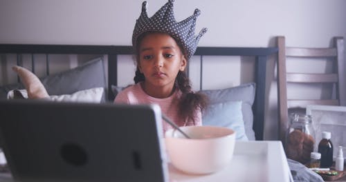 A Young Girl Watching on the Digital Tablet