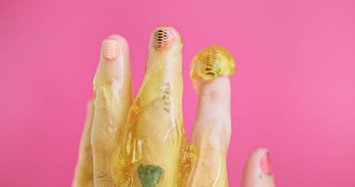 Close Up Shot of Fingers with Yellow Slime