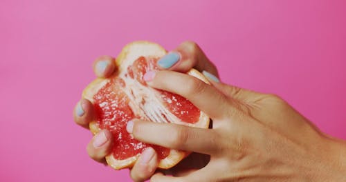 A Person Squeezing a Grapefruit