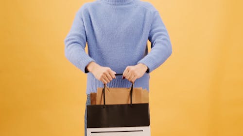 A Man Holding Black Friday Shopping Bags