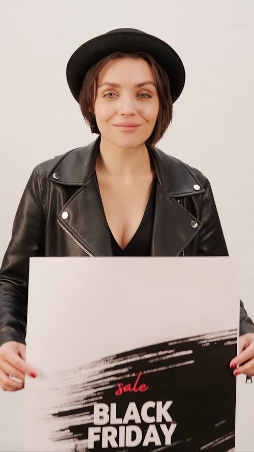 A Woman Holding A Black Friday Sale Posters