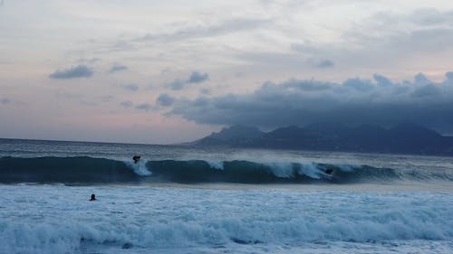 Wide Shot Video of People Riding Big Waves