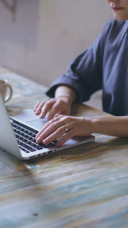 Woman Typing in a Laptop