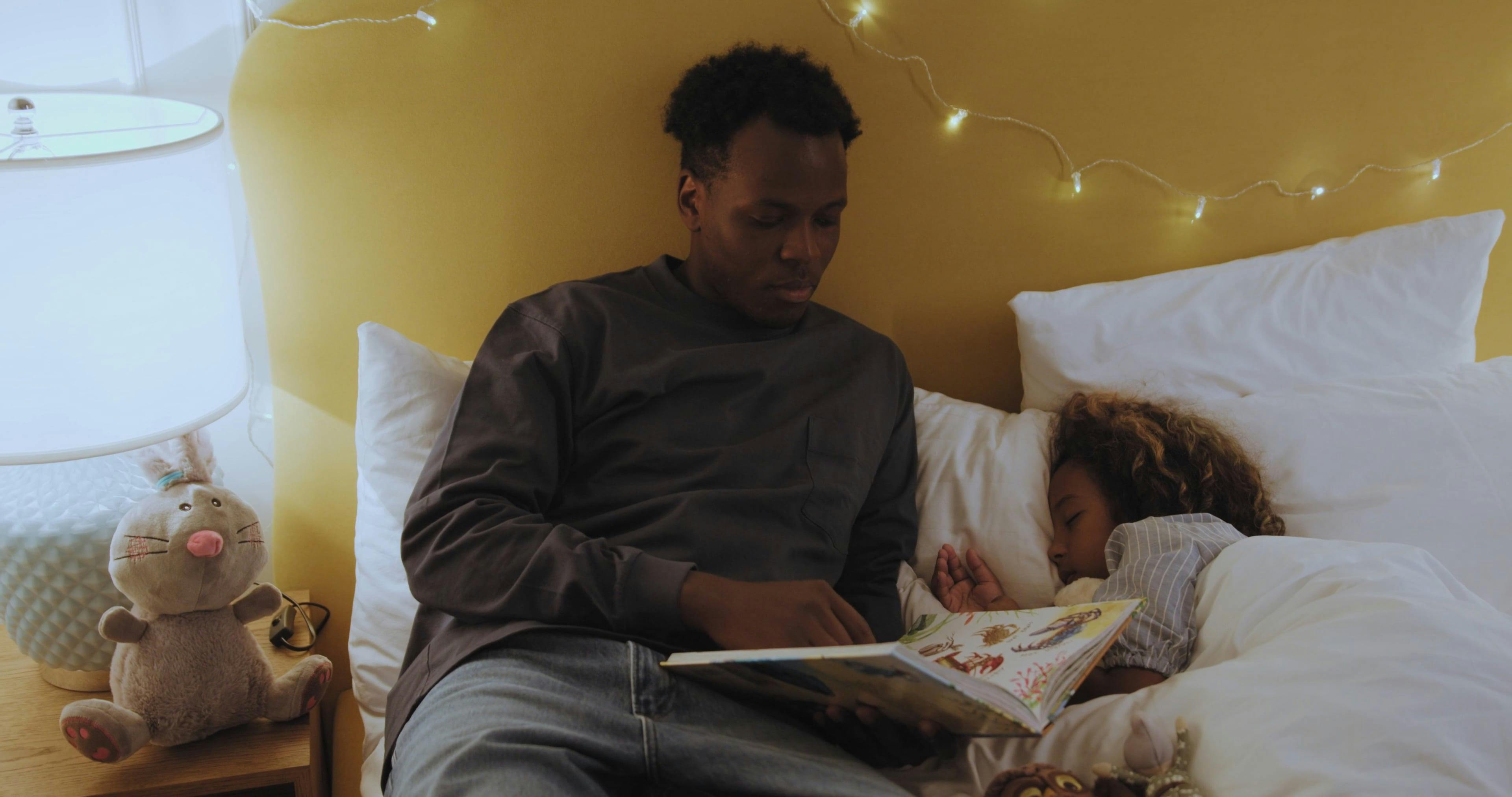 Father Reading Bed Time Stories to His Daughter · Free Stock Video