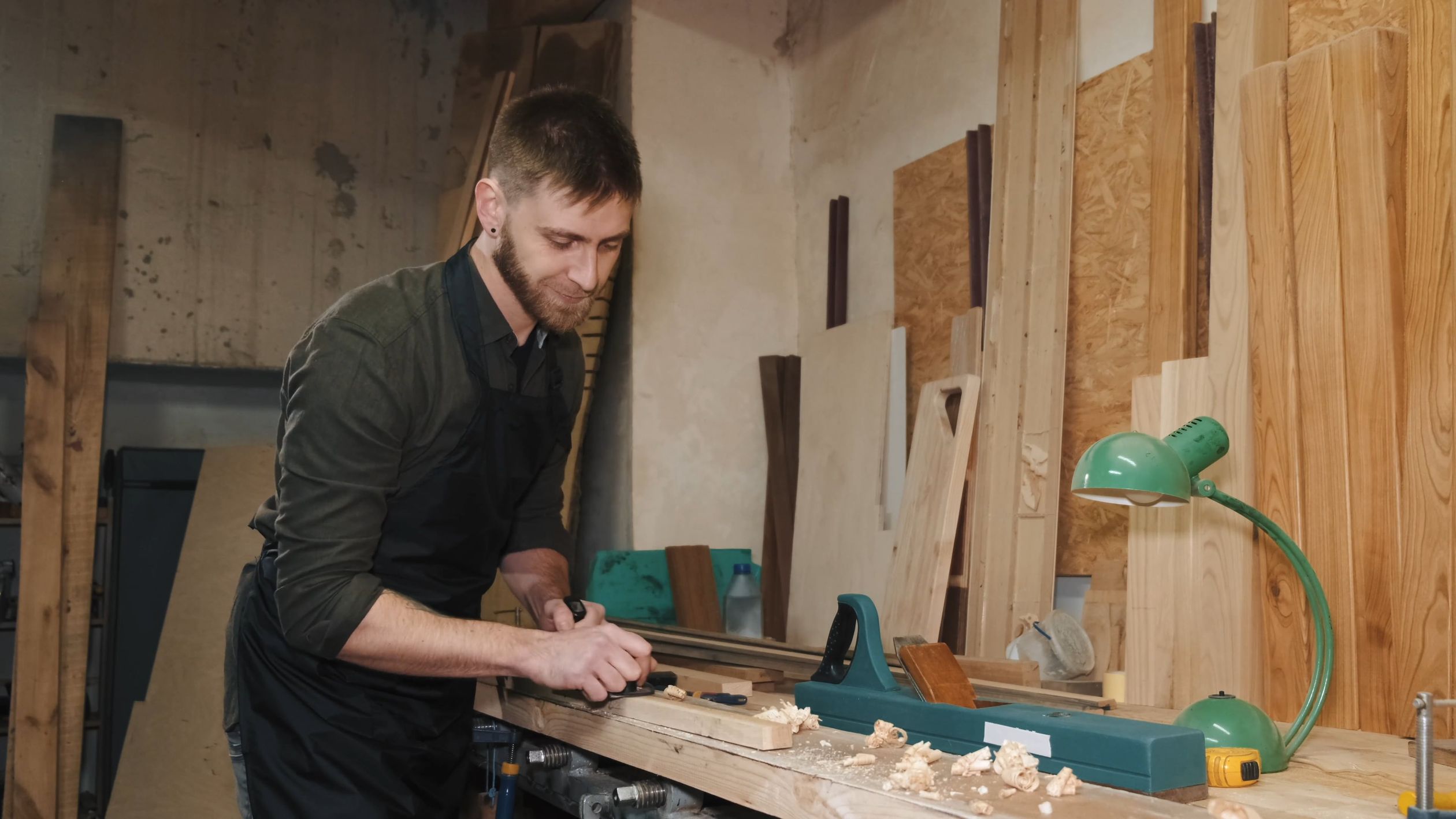Illustrative woodworking scene: a craftsperson shaping wood by hand
