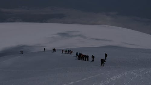 People Hiking on a Snowy Mountain