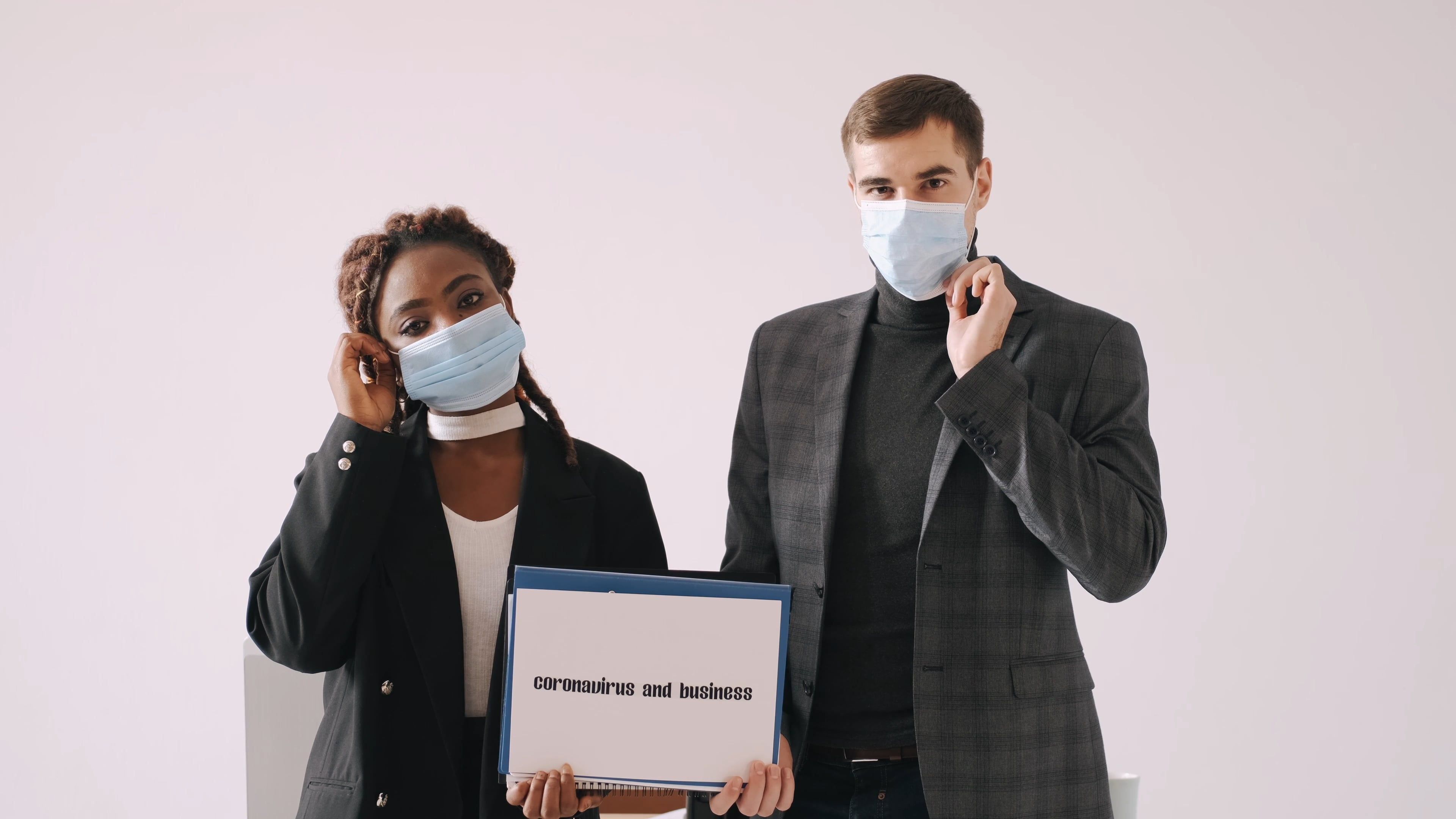 People Wearing Face Masks Holding a Sign · Free Stock Video