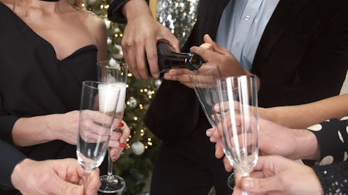 A Person Pouring Champagne in Glasses