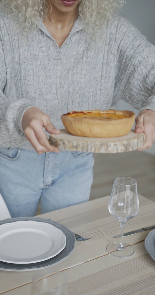 Person Serving Pie on the Table