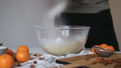 Sifting Flour in Glass Bowl