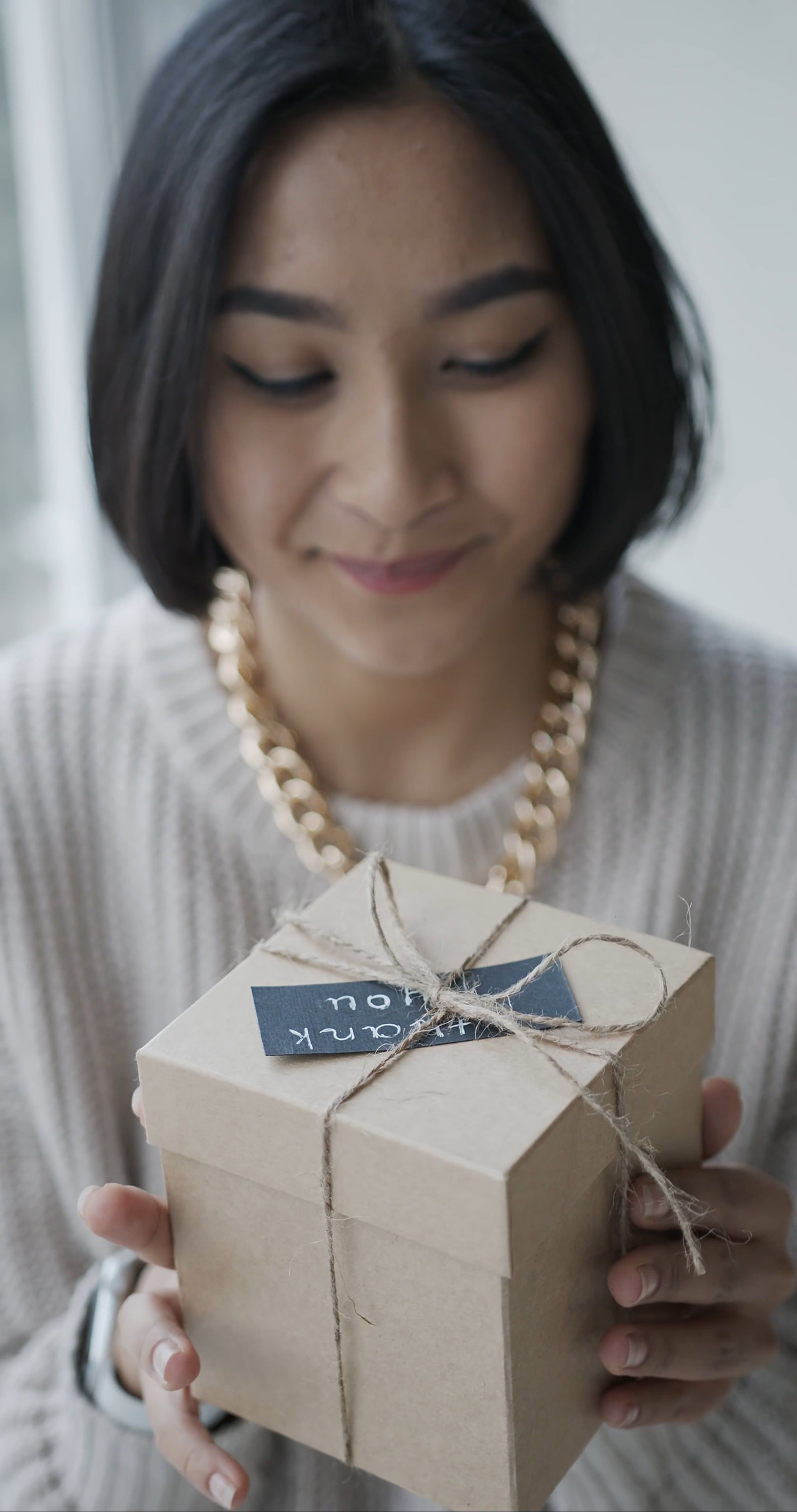 Woman Holding a Gift Box while Smiling · Free Stock Video