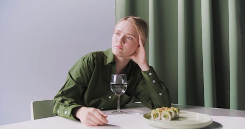 Woman Eating a Sushi Roll