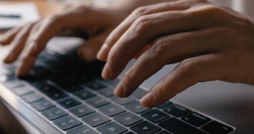 Close-Up Video of Hands Typing on a Laptop