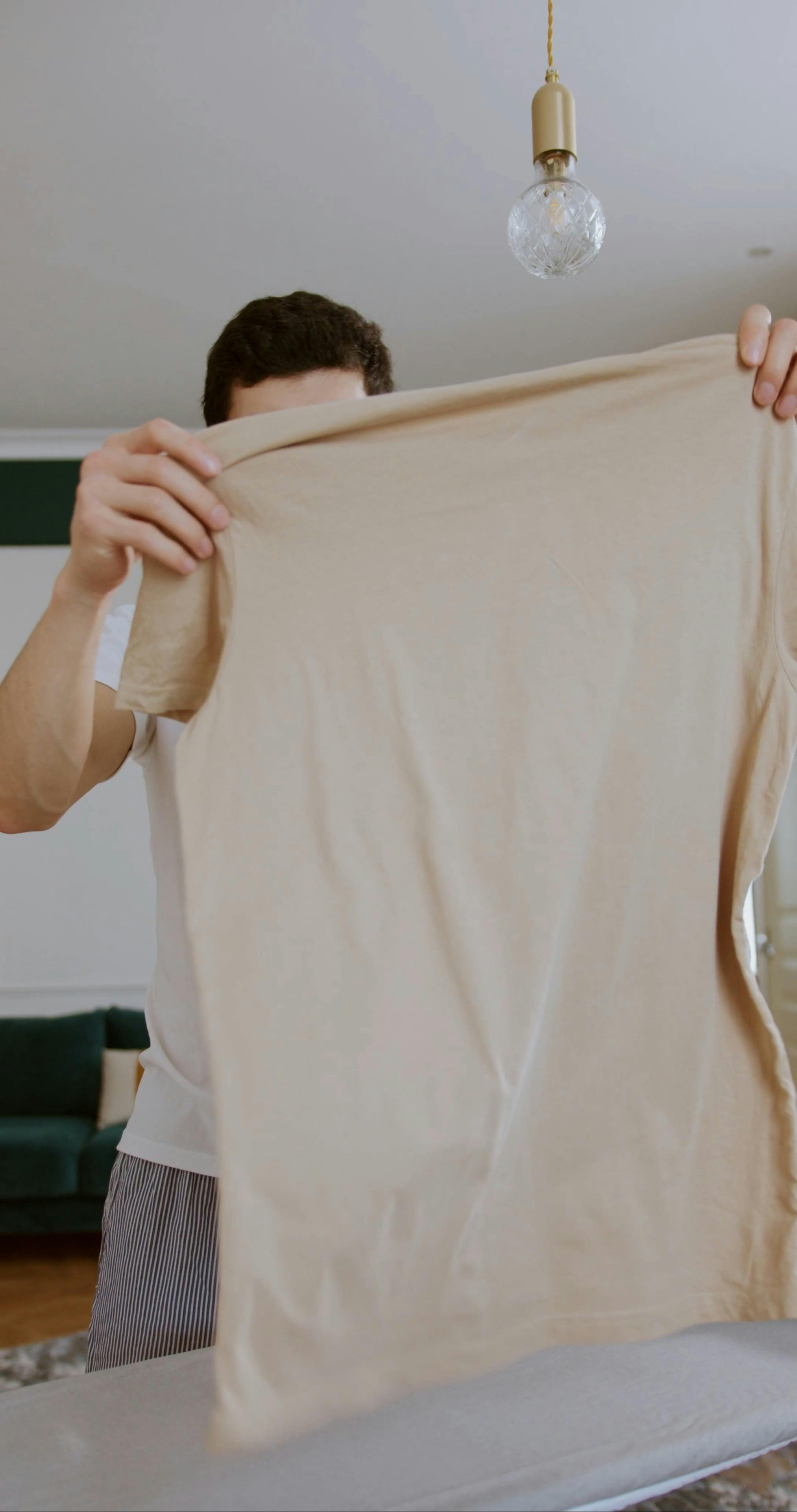 A Man Ironing a Tshirt · Free Stock Video