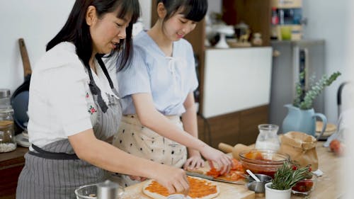 Mom and Daughter Making Pizza