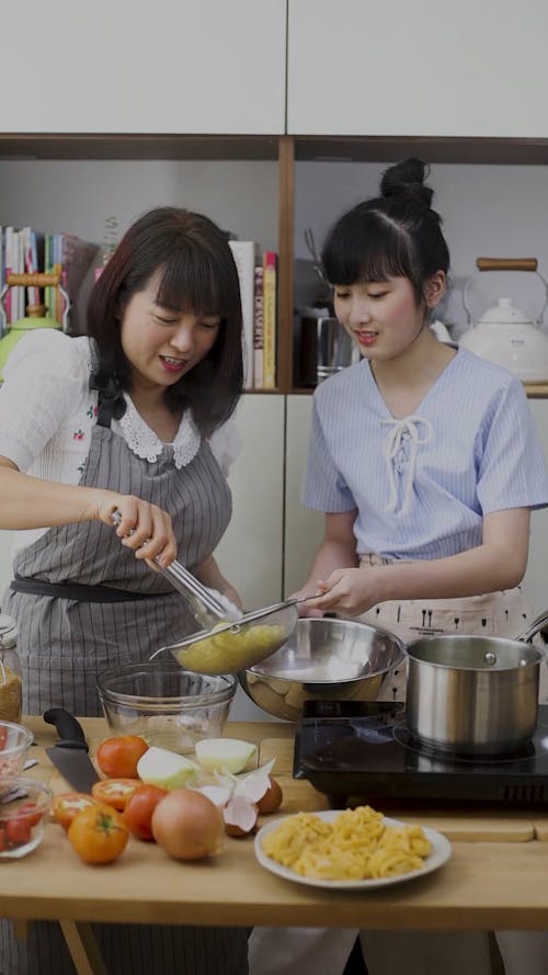 Mom and Daughter Making Noodles 