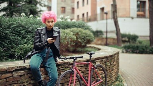 Woman Wearing Leather Jacket Using Cellphone