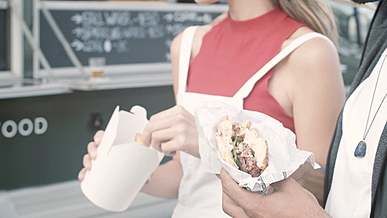 two people eating street food