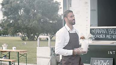 waiter serving takeaway food to a couple