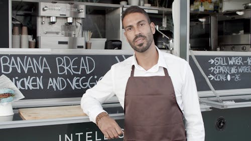 Man Standing In Front of His Food Truck